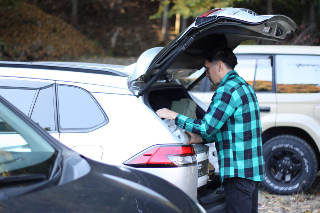 筆者が車から荷物を降ろしているところ