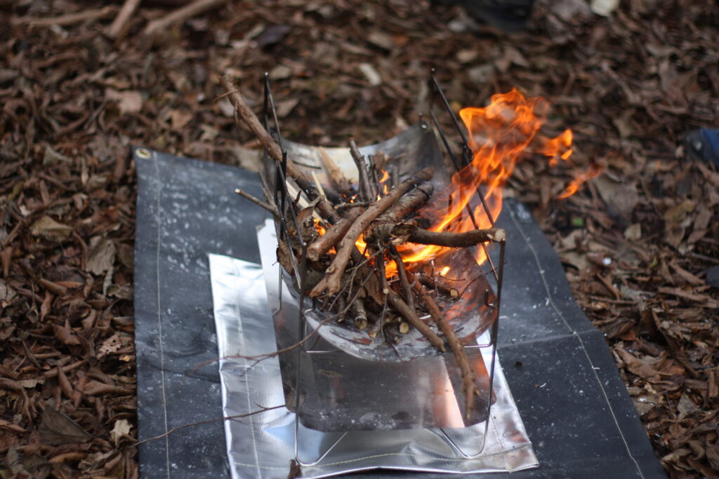 筆者が、焚き火シートを使っているところ